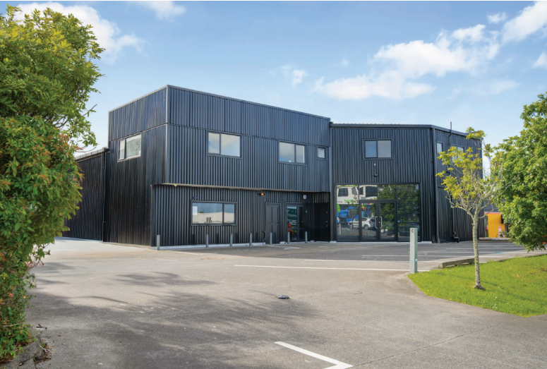 Black clad retail and showroom building in Westgate, Auckland